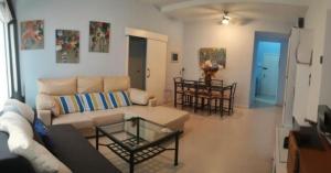 a living room with a couch and a table at Apartamento la paz. Un lugar para descansar. in Isla Cristina
