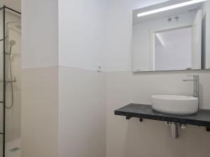 a white bathroom with a sink and a mirror at Estudio Temporal a 2' de la playa de Sagunto A2 in Puerto de Sagunto