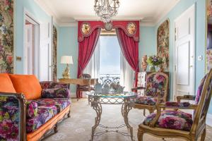 a living room with a couch and a table at Hotel Le Negresco in Nice