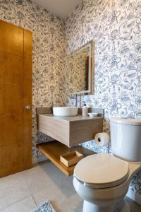 a bathroom with a toilet and a sink at Ocean Home Sweet Home - Suite 3 in Rosarito