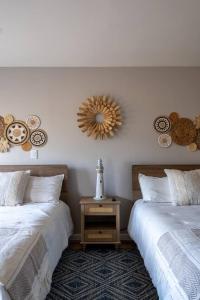 a bedroom with two beds and a mirror on the wall at Ocean Home Sweet Home - Suite 4 in Rosarito