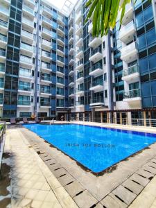 a swimming pool in front of some apartment buildings at Condotel Near Naia Terminal 3 in Manila