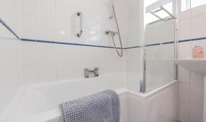 a white bathroom with a shower and a sink at St Elmo in Southwold +19 photos