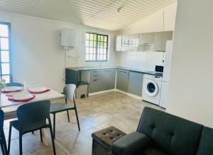a kitchen and living room with a table and chairs at Casa da alegria in Vieira de Leiria