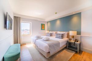 VIP Executive Suites do Marquês Hotel客房内的一张或多张床位