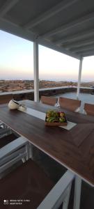 a sandwich on a wooden table with a view of the desert at Avlidaki house in Exámbela