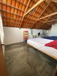 a bedroom with a bed and a concrete floor at Chalé Vista Encanto dos Montes in Monte das Gameleiras +20 photos