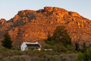a small house in front of a mountain at Alpha Excelsior Guest Farm in Cederberg