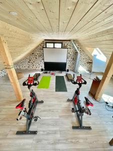 a gym with three treadmills and a white board at Etape en Barétous - 6 personnes in Aramits