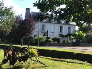a statue of a tractor in front of a house at Etape en Barétous - 6 personnes in Aramits