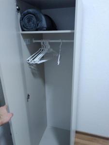 a closet with a glass door with a hanger at Sky Appartment in Koblenz