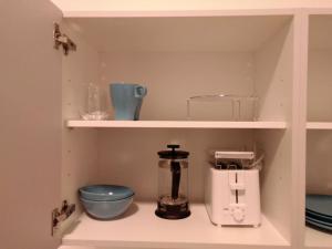 a kitchen shelf with a blender and other kitchen items at Sky Appartment in Koblenz
