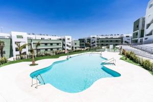 a large swimming pool in the middle of a building at Ultimate Rentals - Ipanema Del Sol - Relax With Scenic Views in Mijas