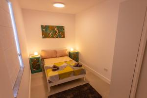 a small room with a bed with two lit candles at Penthouse Cathedral and Seaview Terrace V2 in Valletta