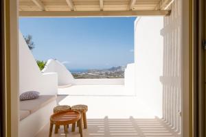 a room with a view of the ocean from a house at White Orchid Villa in Pyrgos