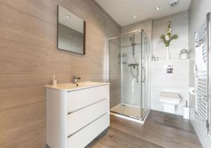 a bathroom with a sink and a shower and a toilet at Cottage In The Wood in Great Malvern +114 photos