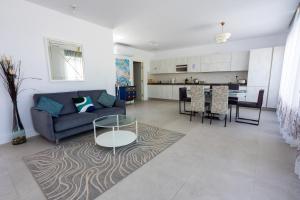 a living room with a couch and a table at Penthouse Cathedral and Seaview Terrace V2 in Valletta +30 photos