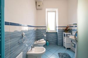 a blue and white bathroom with a sink and a toilet at Casa Nameste 5Terre Holiday Apartment in Brugnato +13 photos