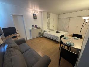 a living room with a couch and a table at Appartement des Champs Elysées in Paris
