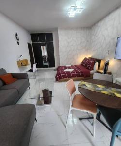 a living room with a couch and a table at Over cloud 1 in Marcory