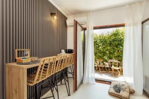 a room with a balcony with a table and chairs at Albizia in Herceg-Novi