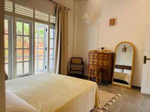 a bedroom with a bed and a dresser and a mirror at Villa Carla Mirissa in Mirissa