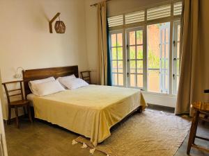 a bedroom with a bed and a large window at Villa Carla Mirissa in Mirissa