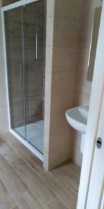 a bathroom with a shower and a toilet and a sink at Camping Il Vecchio Mulino in Opi