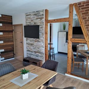 a living room with a table and a brick wall at Fewo Verena mit 2 Schlafzimmern in Diemelsee +19 photos
