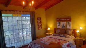 a bedroom with a bed and a large window at La Cipriana in Concepción del Uruguay