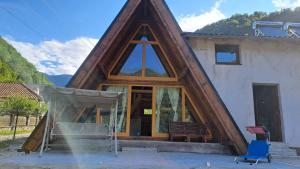 a house with a triangular roof with a window at Lotru Relax A-Frame in Malaia