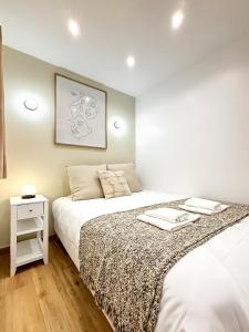 a bedroom with two beds and a night stand at Villa Des Bégonias - PSG in Le Pré-Saint-Gervais