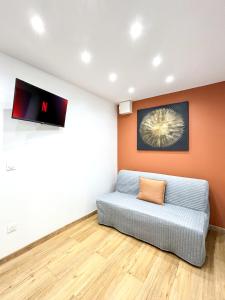 a living room with a couch in the corner at Villa Des Bégonias - PSG in Le Pré-Saint-Gervais +69 photos