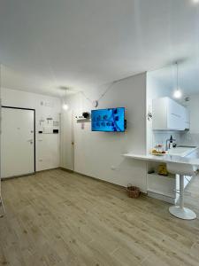a white kitchen with a sink and a counter at La Maison Blanche Otranto in Otranto