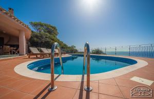 a swimming pool with a view of the ocean at Villa Marisa in Torre delle Stelle