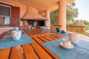a porch with a table and a fireplace at Villa Marisa in Torre delle Stelle +41 photos