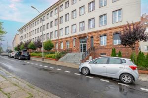 a silver car parked in front of a building at TS Boutique Apartments in Szczecin