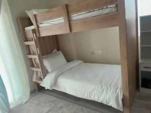 a bedroom with a bunk bed with a ladder at Luxury apartment with balcony, City view in Jeddah