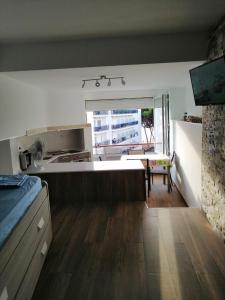a kitchen with a table and a large window at Estudio la Pineda playa in La Pineda