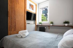 Posteľ alebo postele v izbe v ubytovaní oompH Warsaw Central Apartment