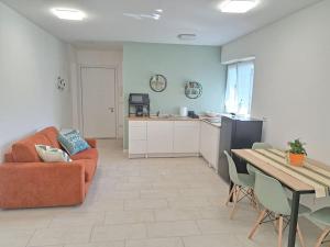 a living room with a couch and a table at Esther house monolocale in Terlano