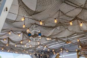 a bunch of lights hanging from a metal ceiling at A Boardwalk Away in Myrtle Beach +88 photos