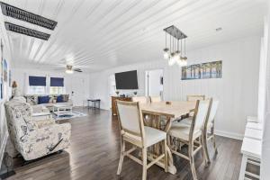 a dining room and living room with a table and chairs at A Boardwalk Away in Myrtle Beach