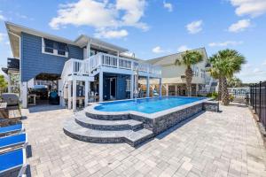a house with a swimming pool in front of a house at A Boardwalk Away in Myrtle Beach