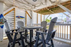 a table and chairs on a porch with a deck at A Boardwalk Away in Myrtle Beach