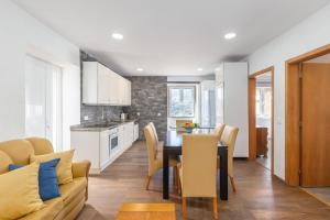 a kitchen and dining room with a table and chairs at NEW! Castel de Paiva in Raiva