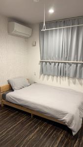 Postel nebo postele na pokoji v ubytování 民泊TOKYO one シェアハウス