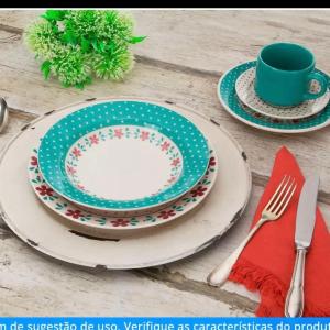 a table with two plates and a cup and a napkin at Lar oliveiras, próximo cento, 500 metros de clube pinheiros in Pato Branco