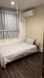 Postel nebo postele na pokoji v ubytování 民泊TOKYO one シェアハウス