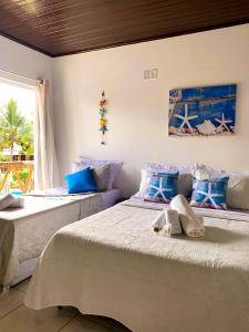 two beds in a room with blue and white at Pousada Oceano Atlântico in Barra Grande +194 photos